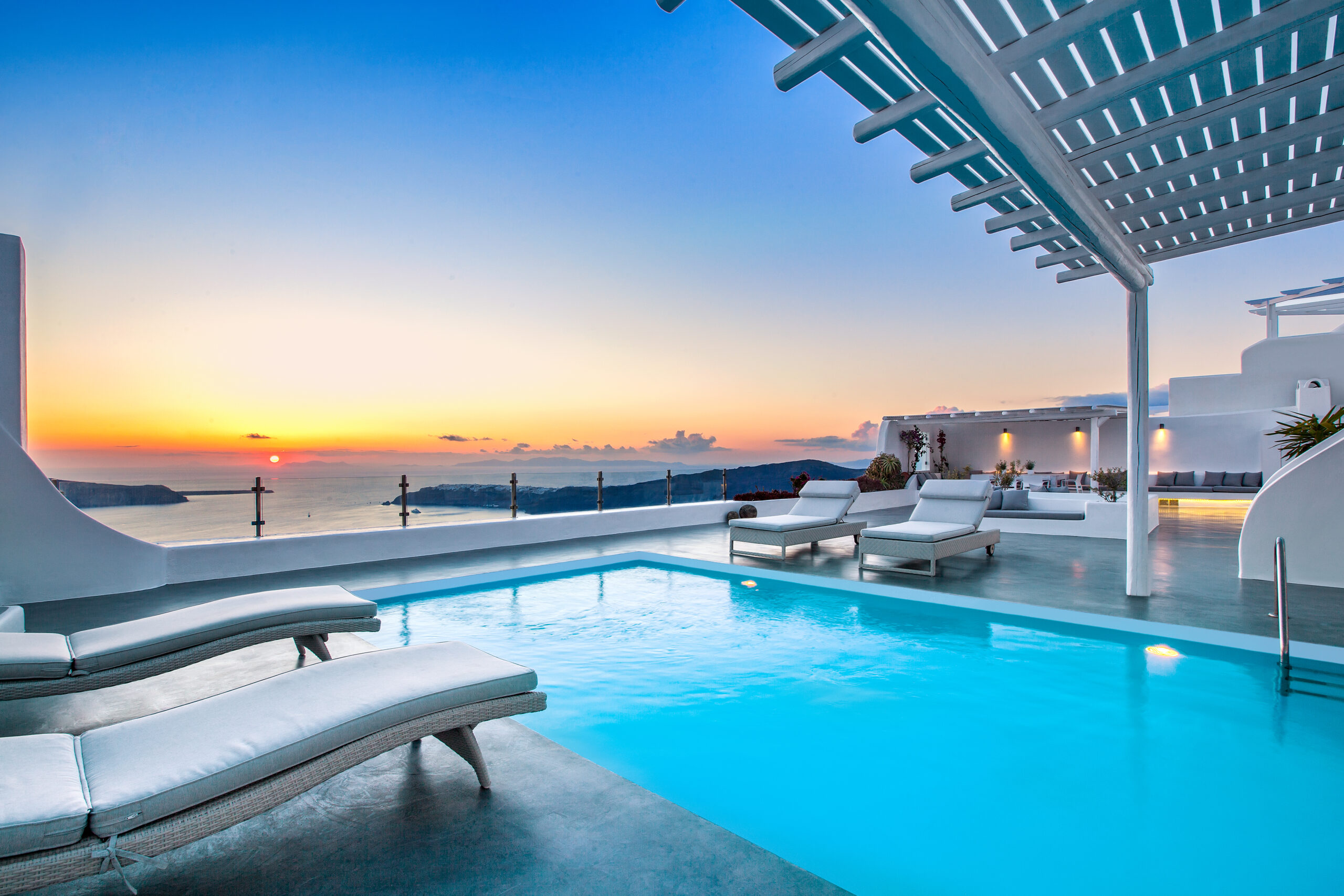 Luxury private villa pool in Santorini at sunset, ideal for celebrations.
