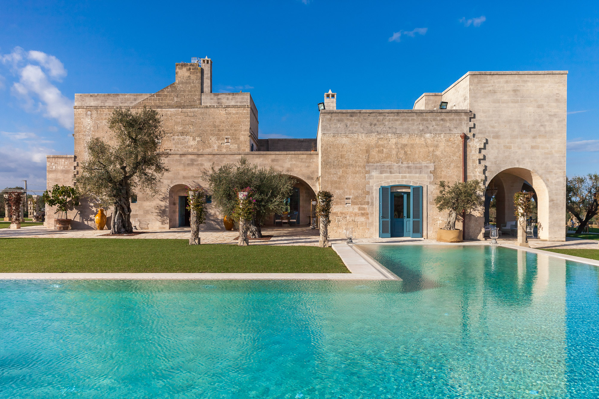 Luxury private celebration villa in Italy with a pool and stone architecture.