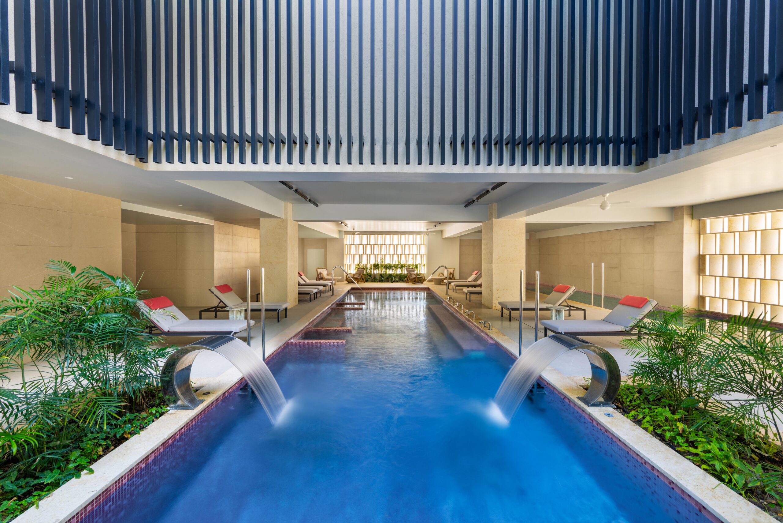 W Punta Cana adult all-inclusive resort spa with a long, narrow pool and lounge chairs.