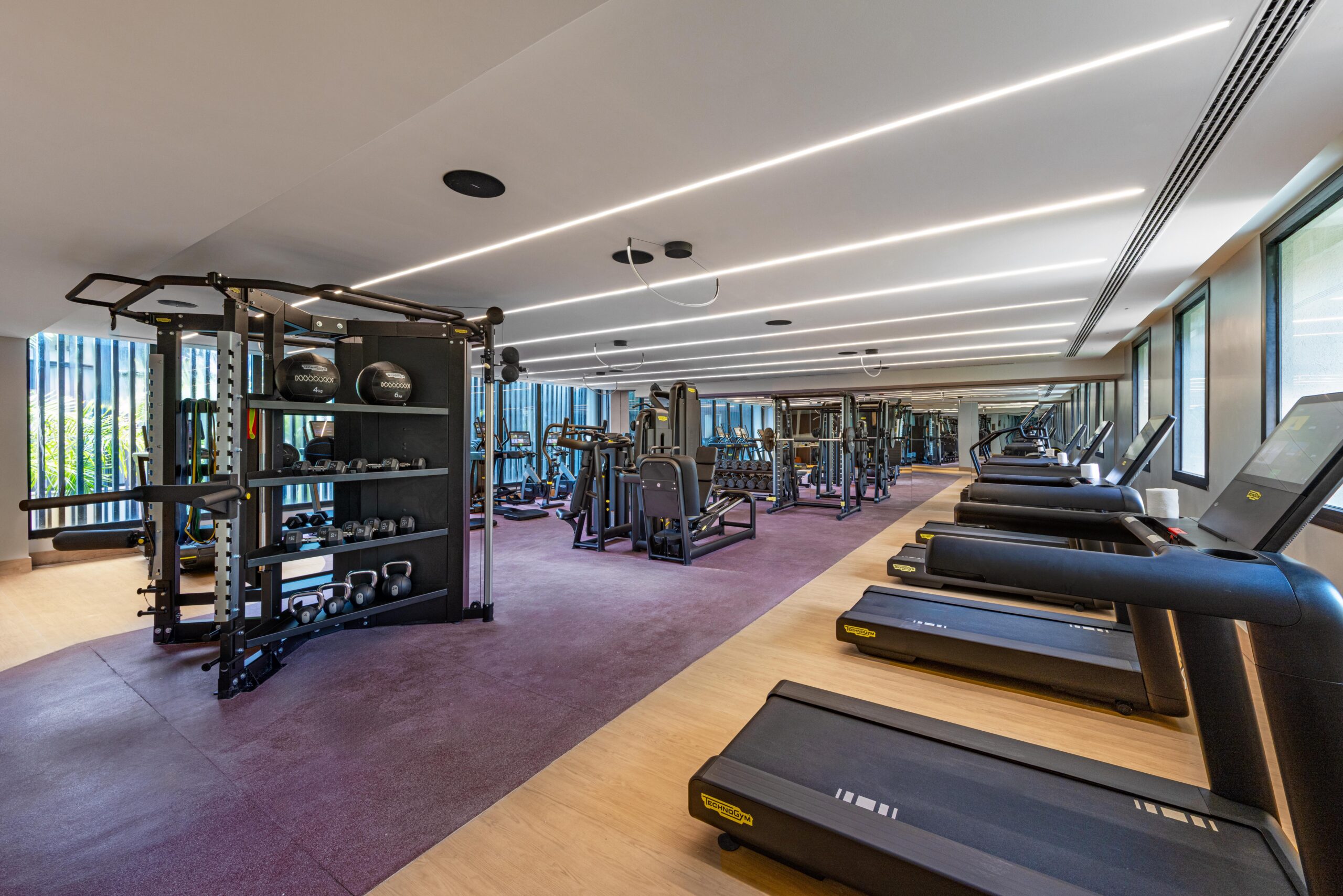 W Punta Cana resort gym with treadmills, weights, and training equipment.