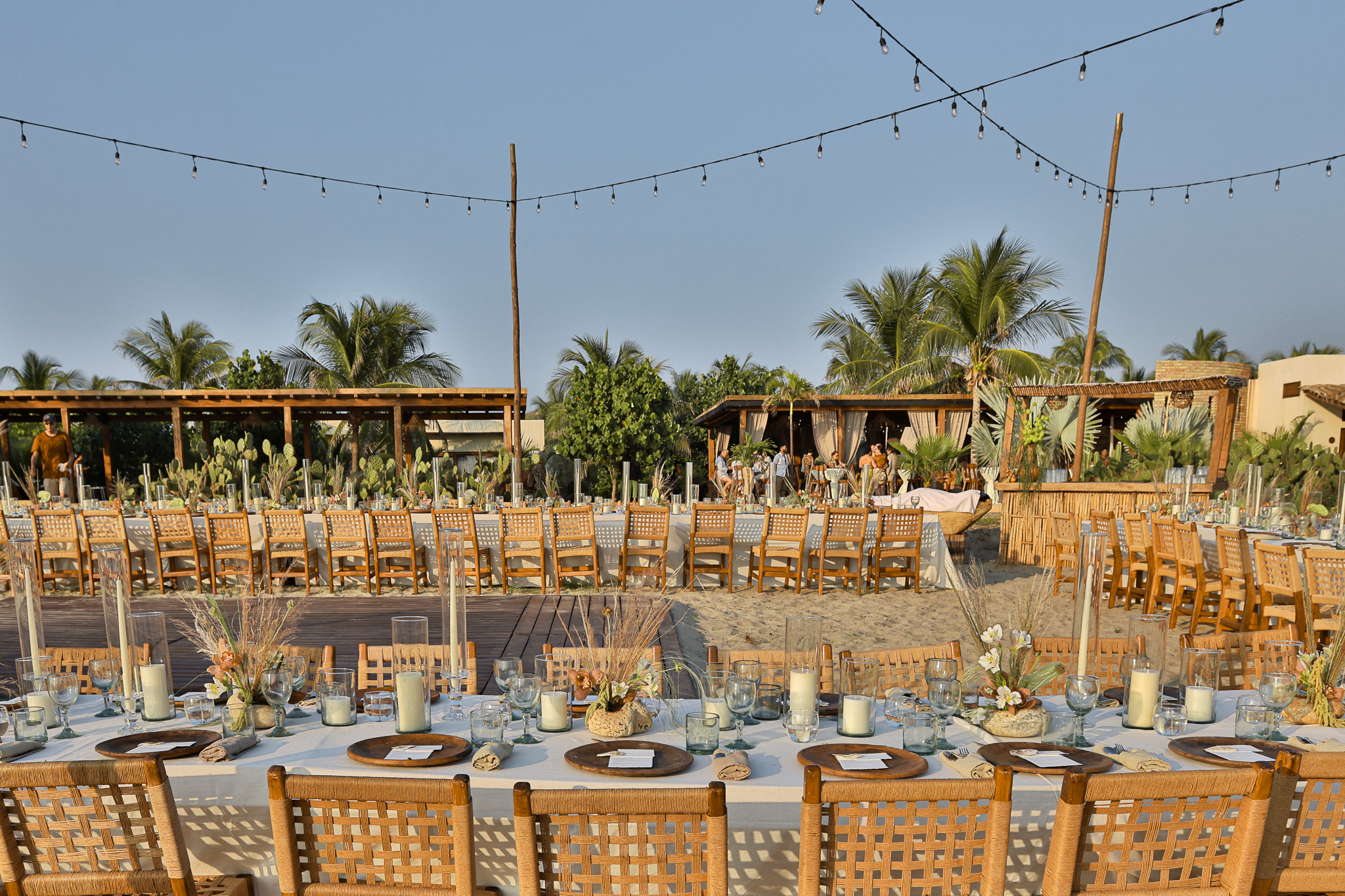 Outdoor wedding reception tables set up at Hotel Casa Yuma with tropical palm trees