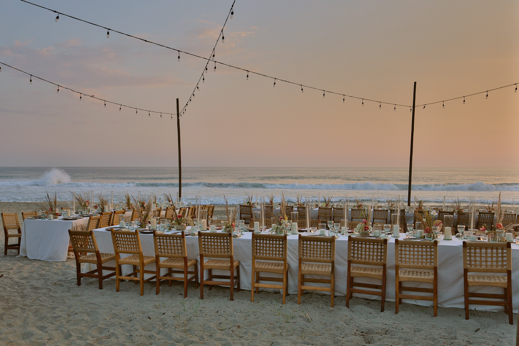 Elegant beachside wedding reception setup at Hotel Casa Yuma with long tables and ocean view