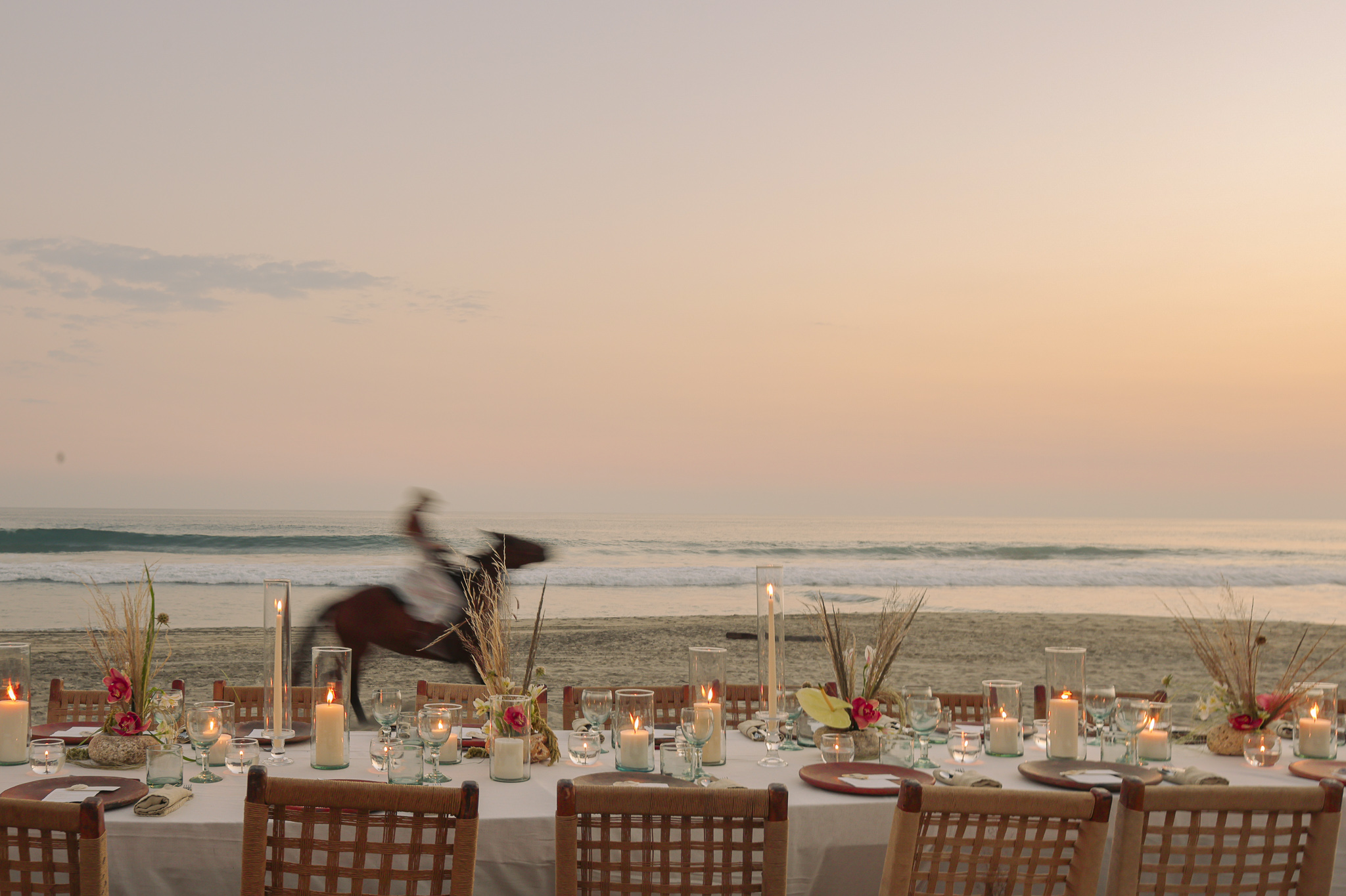 Beachside wedding reception at Hotel Casa Yuma with horse rider in background