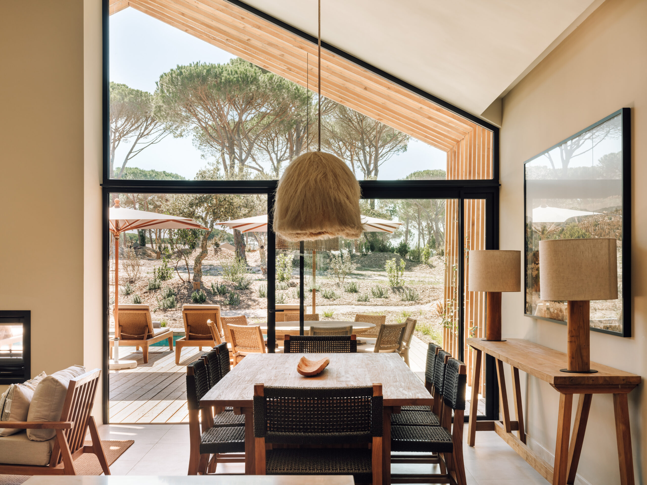 Modern dining room with large windows overlooking a scenic landscape in Sublime Comporta