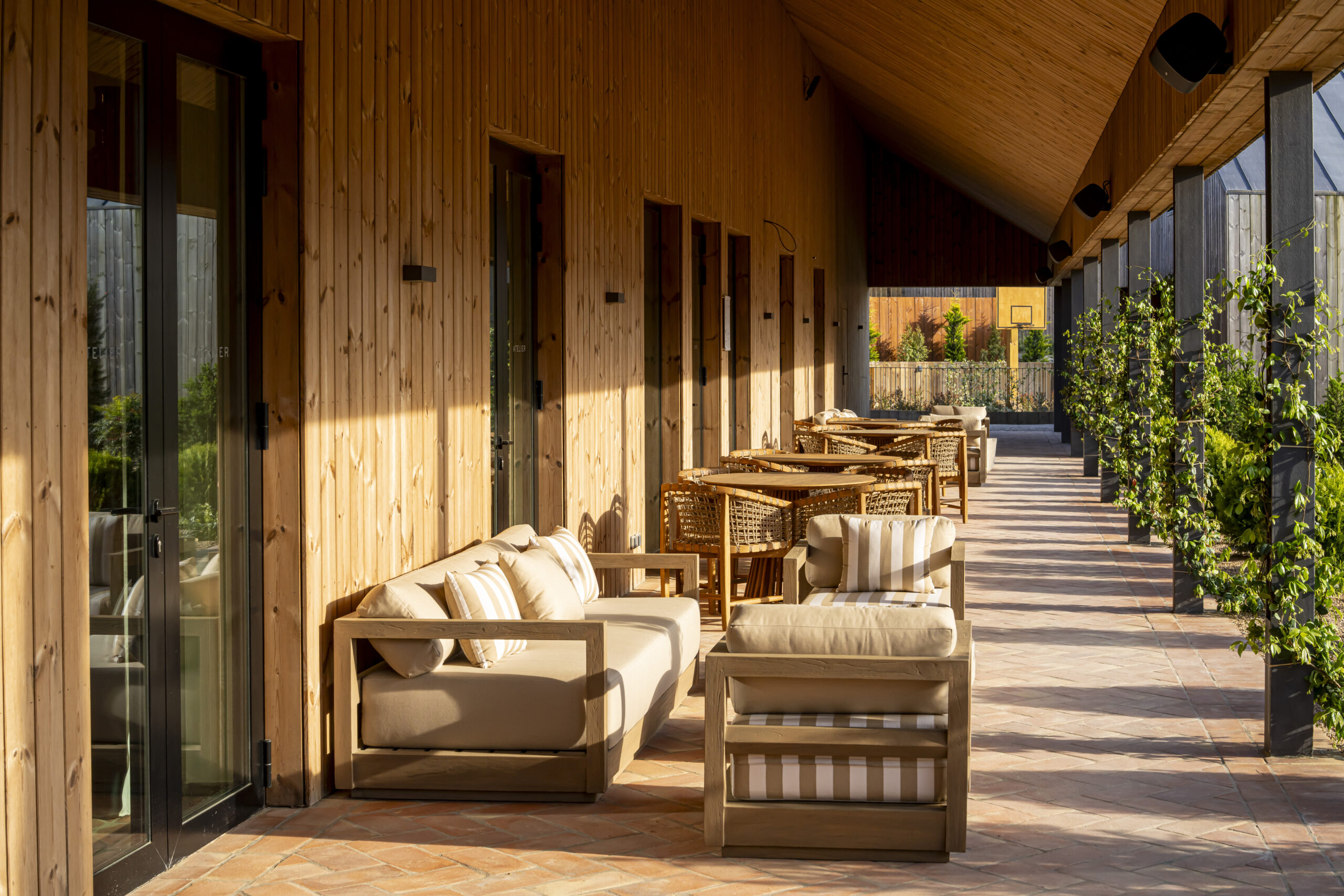 Wooden veranda with outdoor seating and tables at Sublime Comporta