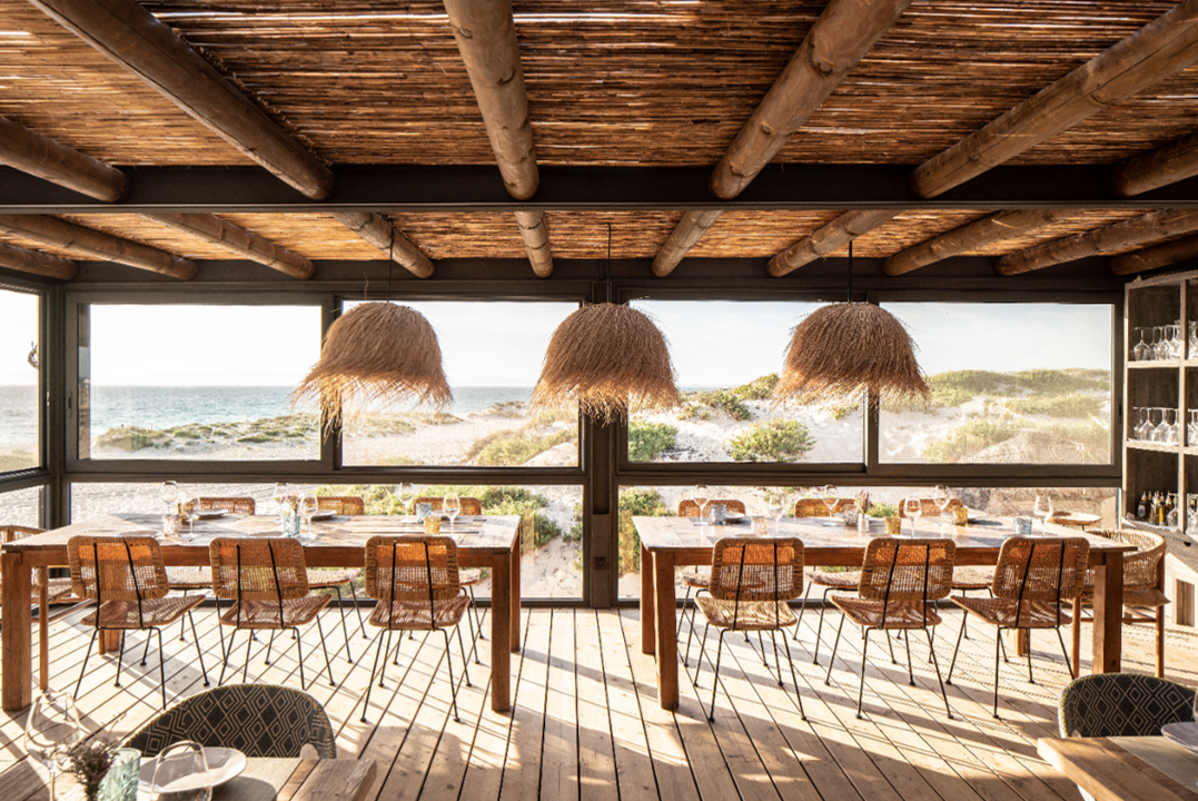 Beachfront restaurant dining tables with ocean view in Sublime Comporta