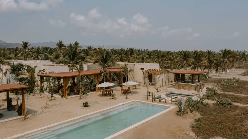 Hotel Casa Yuma: beachfront resort with pool, palm trees, and outdoor dining